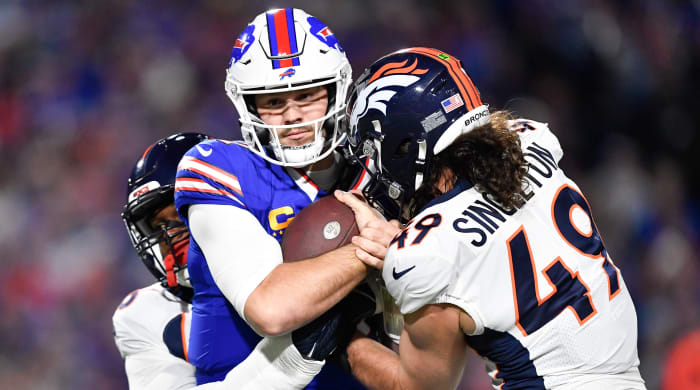Buffalo Bills quarterback Josh Allen is sacked by Denver Broncos' Baron Browning (left) and Alex Singleton (right).